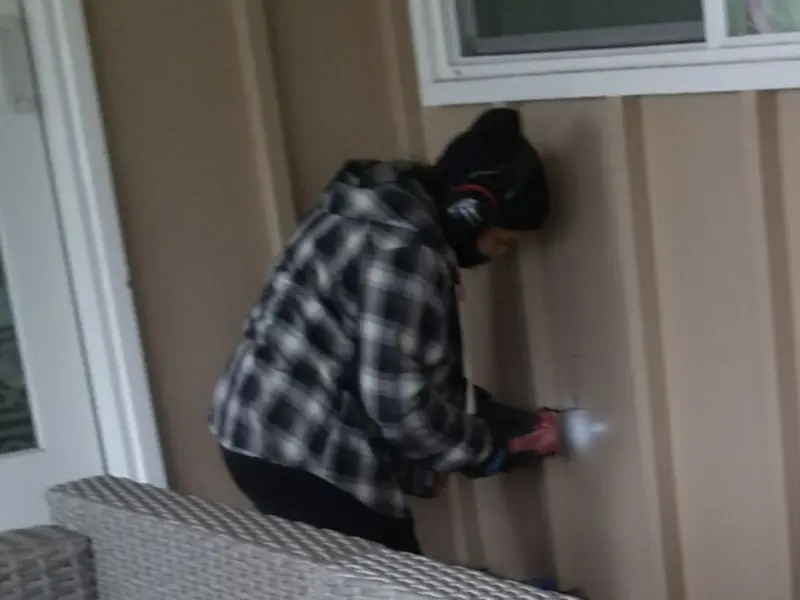 Professional electrician installing an exterior outlet in Riverton